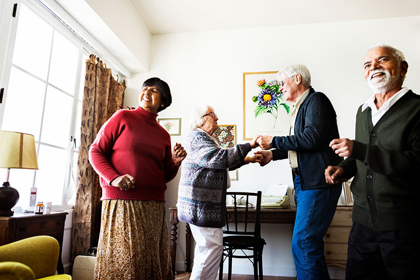 Senior friends dancing together at home Senior friends dancing together at home