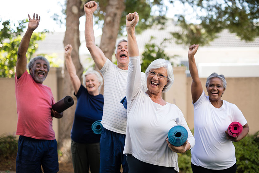 Seniors with exercise mats at park