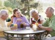 Friends Enjoying A Beverage By A Golf Course