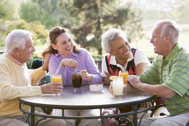Friends Enjoying A Beverage By A Golf Course Friends Enjoying A Beverage By A Golf Course