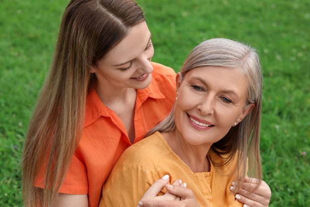 Happy mature mother and her daughter outdoors Happy mature mother and her daughter outdoors