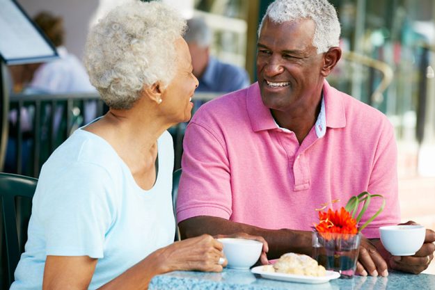 Senior Couple Enjoying Snack At Outdoor Cafe Senior Couple Enjoying Snack At Outdoor Cafe